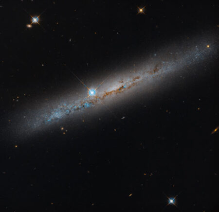 Hubble Space Telescope Discovers Dusty Spiral Galaxy NGC 1827